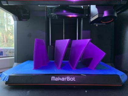 A few freshly printed plastic parts inside a 3D printer