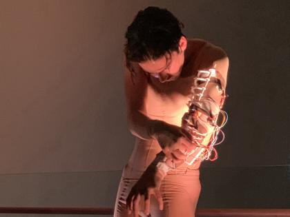 dancer wears a robotic exoskeleton