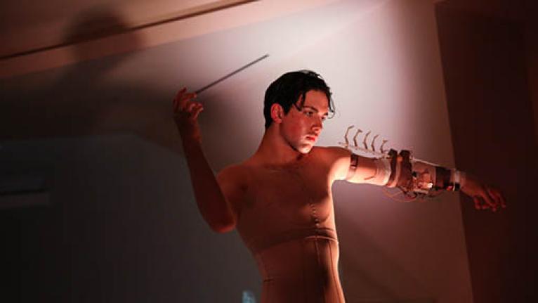 Man holding wand in dramatic pose